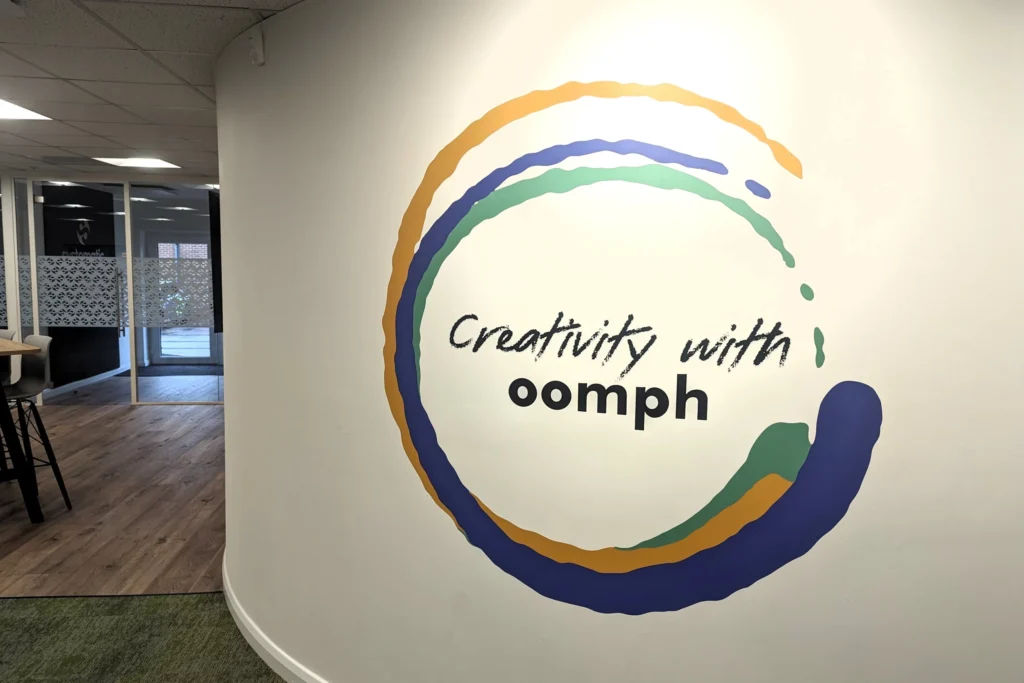 A photo of wall graphics at oodle stating 'Creativity with oomph'