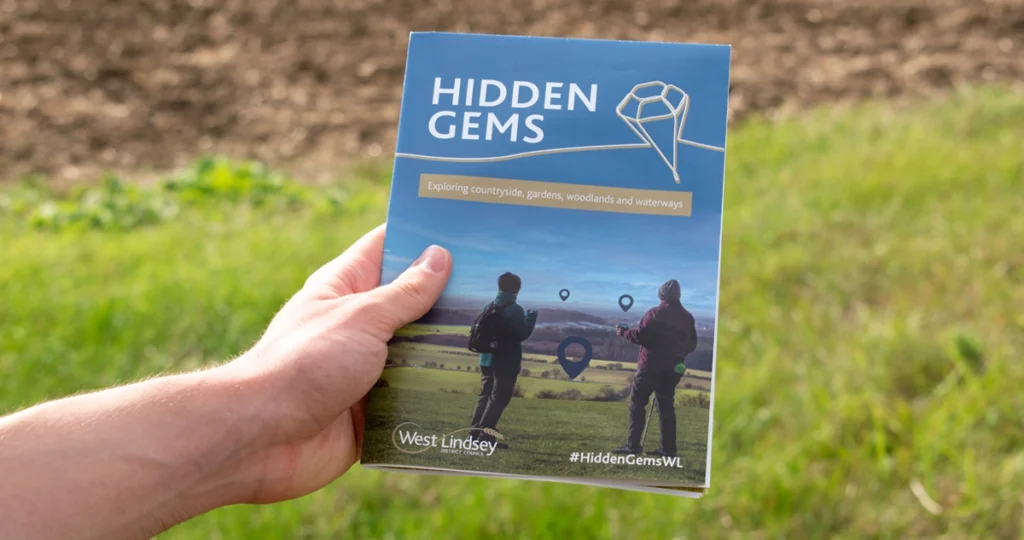 A photograph showing the hidden gems brochure for West Lindsey District Council designed by oodle Agency