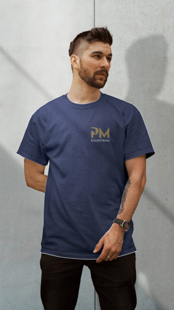 A photo of a male wearing a PM Equestrian branded t-shirt